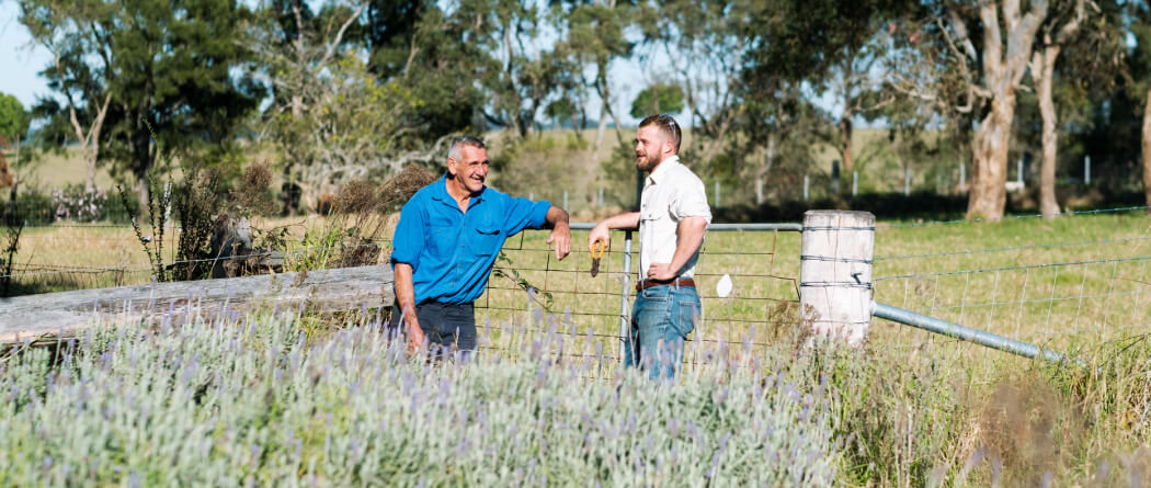 Two men standing outside in a field