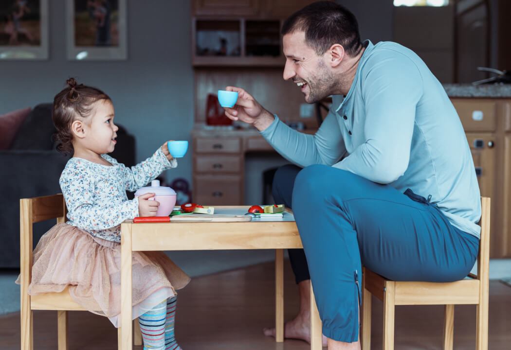 Dad playing tea party with his daughter