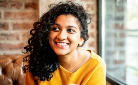 young woman smiling and looking away from the camera 